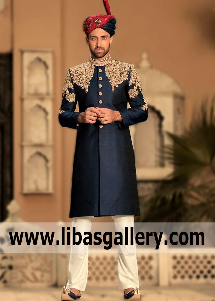 Any gentleman will look beyond praise in a dark blue Jamawar Sherwani suit and off-white kurta and pajama. A pair of khussa shoes Made with sherwani material and embroidery will be the ideal accompaniment for this Groom look.