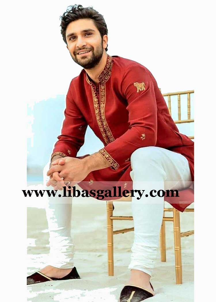 ahaz raza mir sitting on chair in designer Red Eid embroidered kurta with white pajama custom made germany dubai qatar