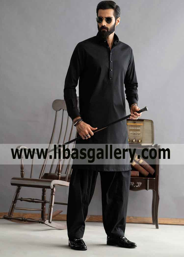 Man with stick wearing jet black kameez shalwar