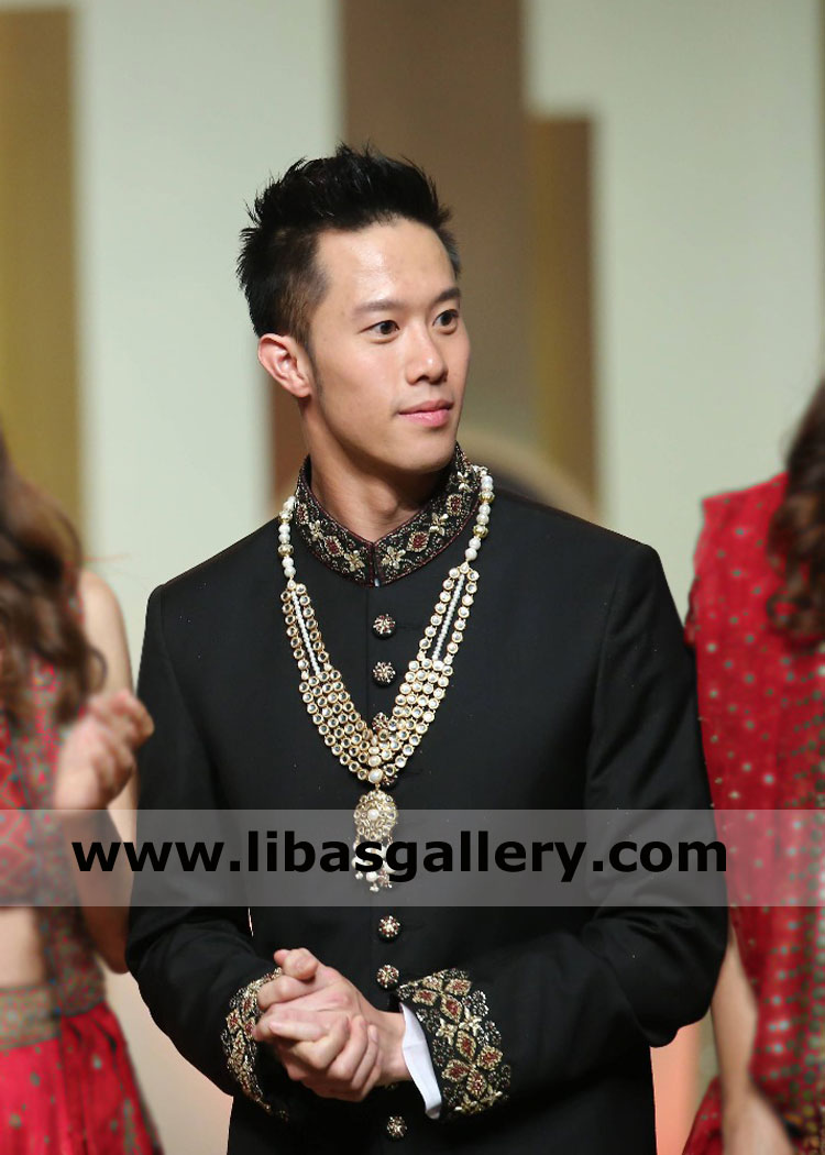 Black Sherwani Groom wearing with pearls mala brooch 