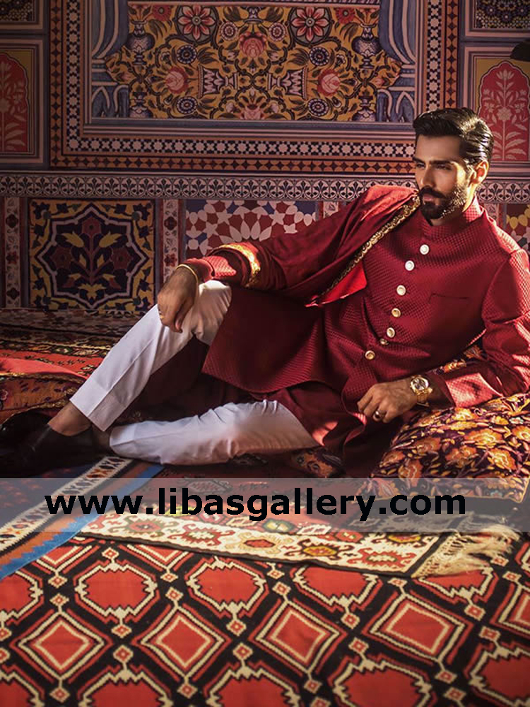 hasnain lehri sitting on carpet like prince of persia in carmine mens sherwani suit for inter city wedding event Maryland Baltimore usa