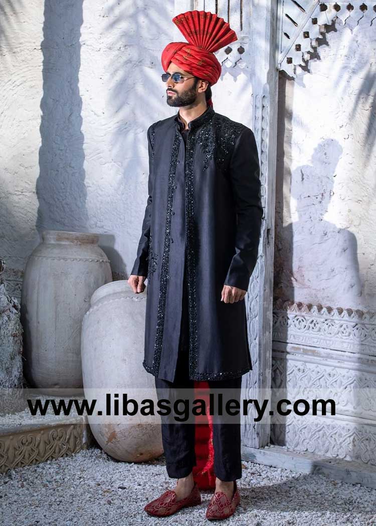 Royal black raw silk Men Wedding sherwani hand embroidered with all black Kora Dabka Naqshi Sitara Pearl Paired with a black Trousers red turban Austin Fort Worth San Jose USA